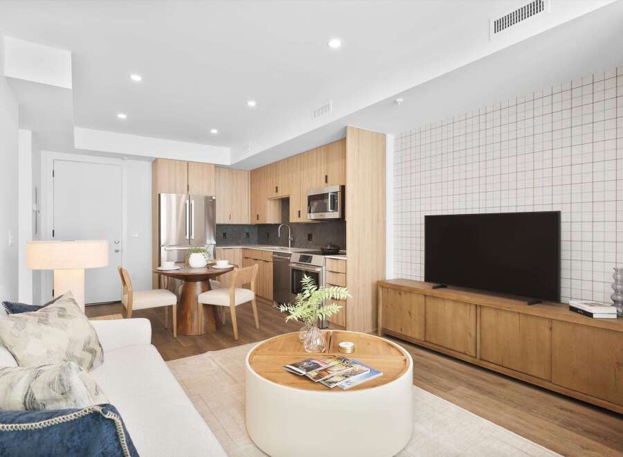 Experience modern living in this stylish apartment featuring a sleek kitchen with stainless steel appliances and ample cabinet space.