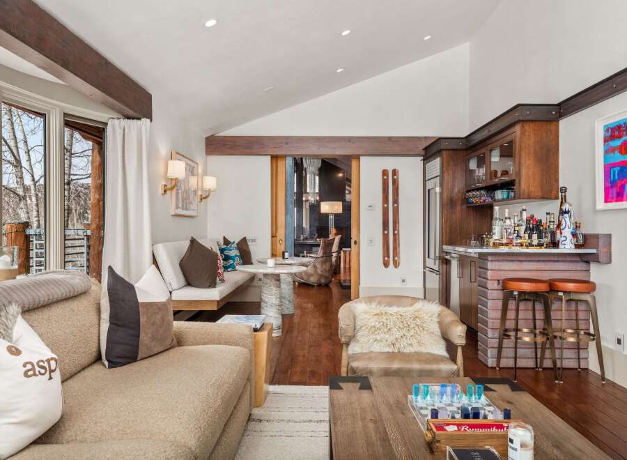 Experience luxury living in this stunning property, featuring a beautifully designed interior with exposed wooden beams and a cozy fireplace.