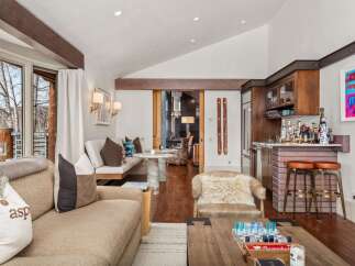 Experience luxury living in this stunning property, featuring a beautifully designed interior with exposed wooden beams and a cozy fireplace.