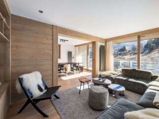 Experience luxury living in this stunning property, featuring a spacious living area with a cozy seating arrangement and a beautiful view.