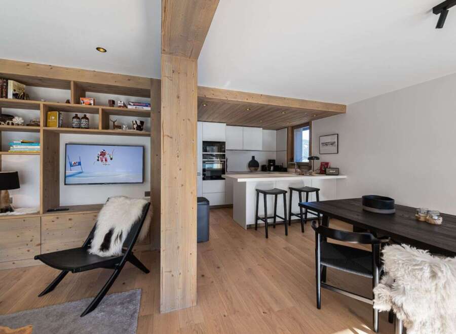 Experience luxury living in this stunning property, featuring a modern kitchen with sleek appliances and a cozy living area with a fireplace.