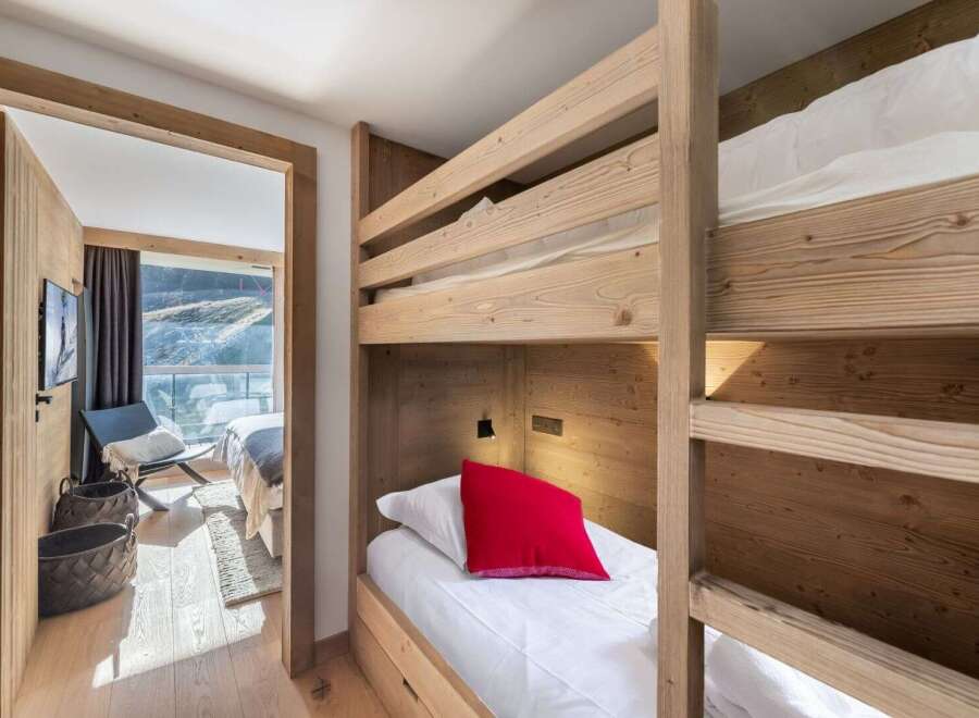 Discover the charm of this cozy bedroom featuring a unique bunk bed design, perfect for family or guest accommodations.