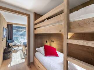 Discover the charm of this cozy bedroom featuring a unique bunk bed design, perfect for family or guest accommodations.