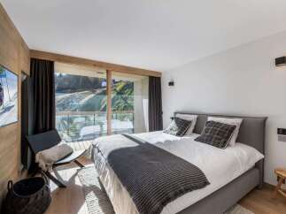 Experience luxury living in this stunning bedroom with breathtaking views.