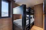 This cozy bedroom features a stylish bunk bed, perfect for accommodating guests or family members.
