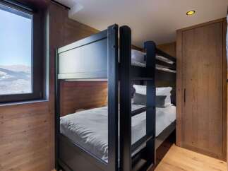 This cozy bedroom features a stylish bunk bed, perfect for accommodating guests or family members.