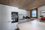 This modern kitchen boasts sleek white cabinetry and a minimalist design, perfect for a contemporary home.