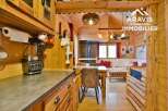 Discover the charm of this stunning property, featuring a cozy interior with wooden accents and a well-equipped kitchen.