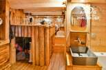 Discover the charm of this unique property featuring rustic wooden interiors and a cozy loft bed.