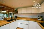 This stunning kitchen boasts a modern design with sleek white cabinetry and warm wooden countertops, creating a perfect blend of style and functionality.