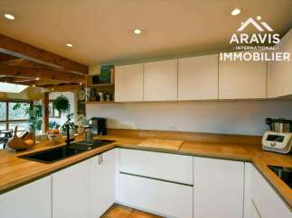 This stunning kitchen boasts a modern design with sleek white cabinetry and warm wooden countertops, creating a perfect blend of style and functionality.