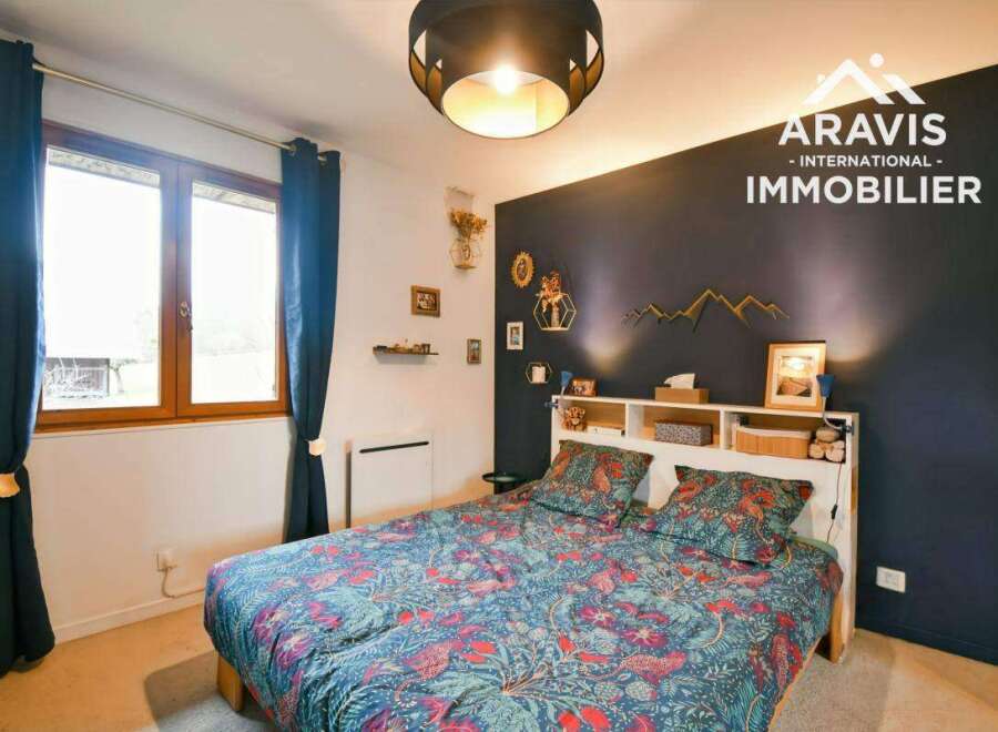 Discover this charming bedroom featuring a cozy bed adorned with vibrant floral bedding.