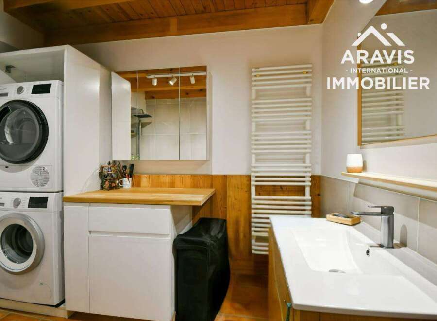 Discover this charming property featuring a modern laundry area with stacked washer and dryer, perfect for efficient living.