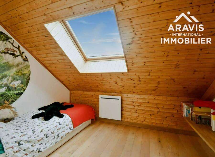 Discover this charming attic bedroom, featuring a unique skylight that floods the space with natural light.