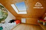 Discover this charming attic bedroom, featuring a unique skylight that floods the space with natural light.