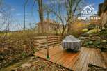 Discover a charming property with a wooden deck overlooking a serene stream.