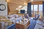 This stunning living room boasts a cozy ambiance with its wooden ceiling and inviting decor.