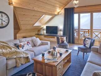 This stunning living room boasts a cozy ambiance with its wooden ceiling and inviting decor.