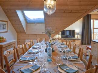 Experience the charm of this stunning property, featuring a beautifully set dining table perfect for hosting gatherings.