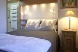 This cozy bedroom features a comfortable bed with stylish bedding, perfect for a relaxing retreat.
