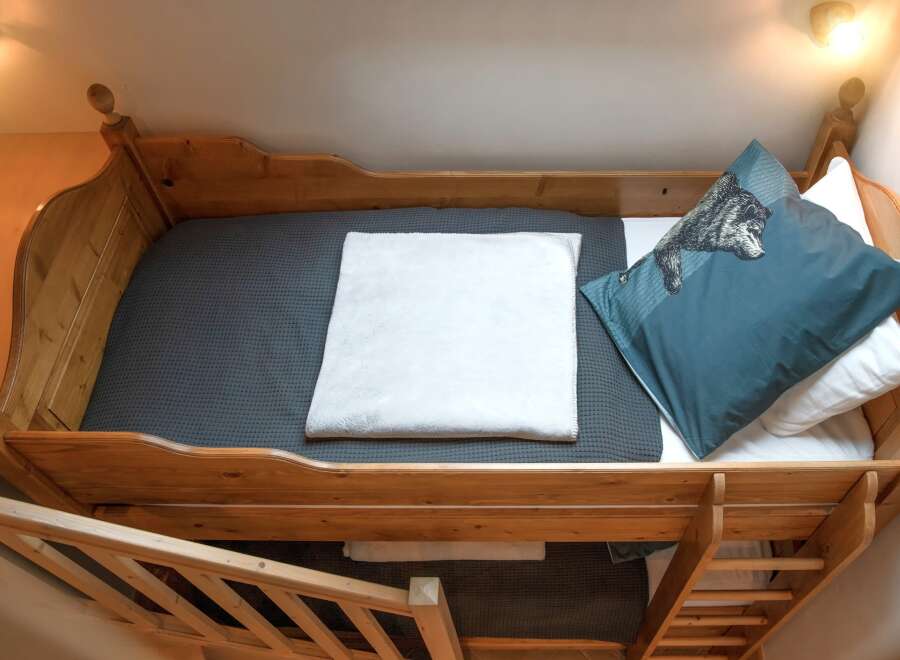 This cozy bunk bed is perfect for a guest room or a kid's bedroom.