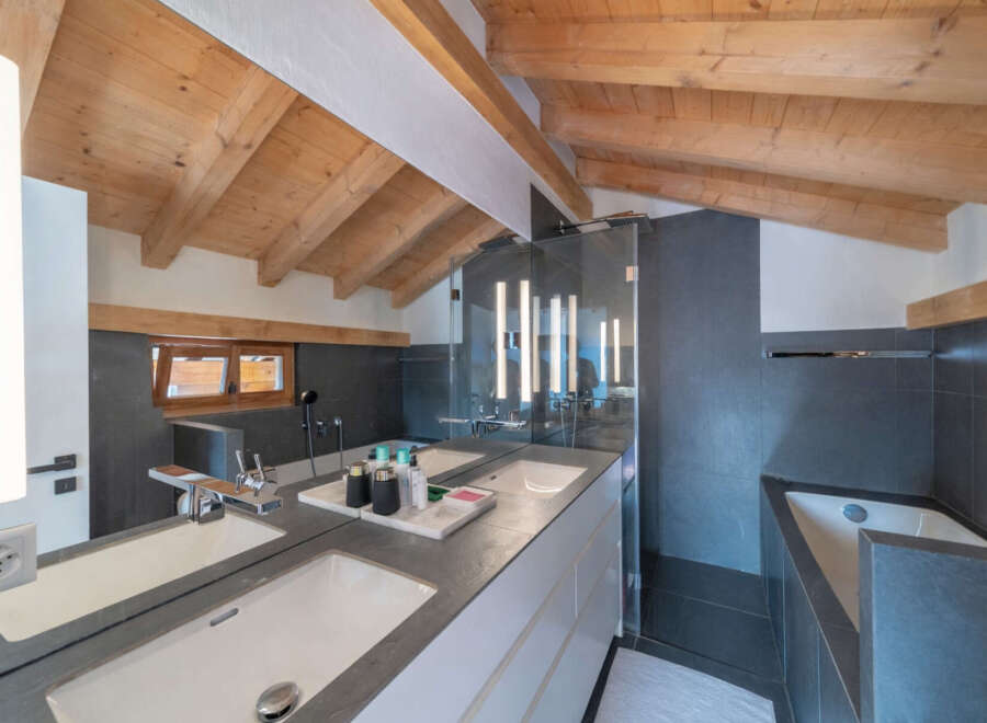This luxurious bathroom boasts a modern design with a touch of rustic charm.