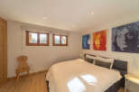 This cozy bedroom features a comfortable bed, perfect for a relaxing night's sleep.