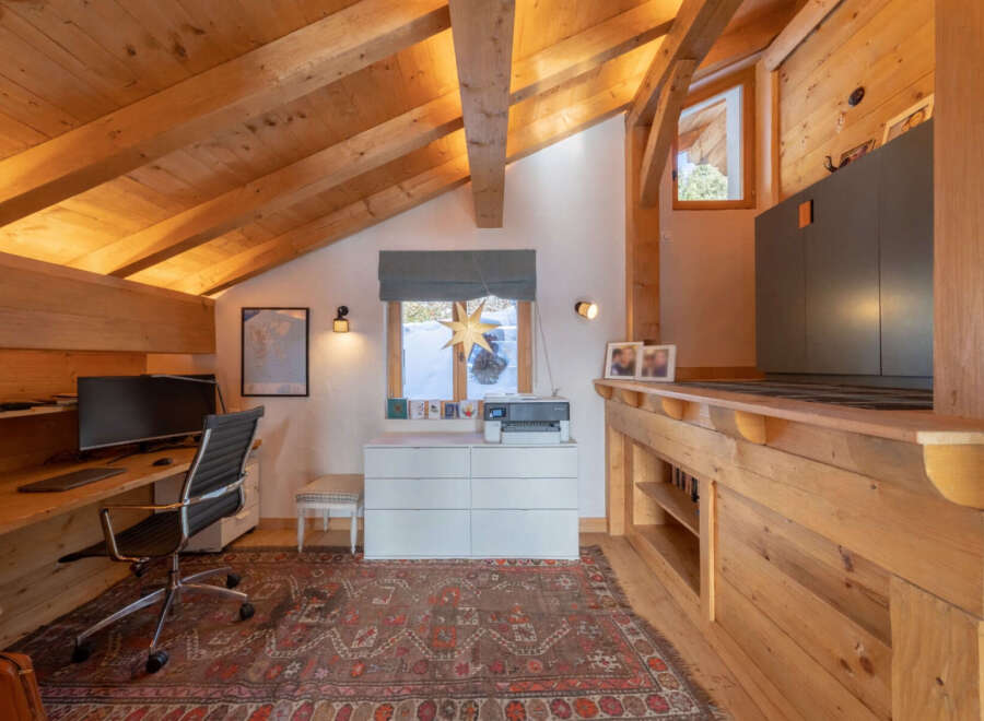 This stunning property features a cozy home office with a unique wooden ceiling and a warm, inviting atmosphere.