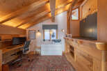 This stunning property features a cozy home office with a unique wooden ceiling and a warm, inviting atmosphere.