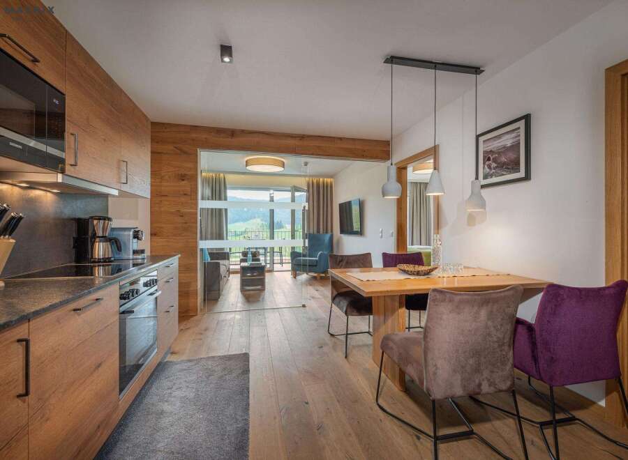 Experience luxury living in this stunning property, featuring a modern kitchen with high-end appliances and sleek design.