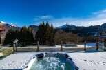 Enjoy breathtaking mountain views from this luxurious property featuring a private hot tub.