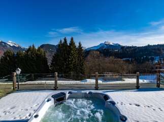 Enjoy breathtaking mountain views from this luxurious property featuring a private hot tub.