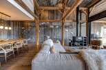 Experience rustic luxury in this stunning property, featuring exposed wooden beams and a cozy fireplace.