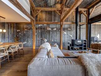 Experience rustic luxury in this stunning property, featuring exposed wooden beams and a cozy fireplace.