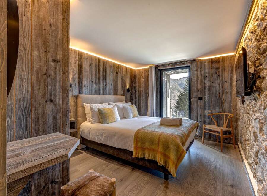 Experience rustic luxury in this stunning bedroom.