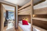 This cozy bedroom features a unique bunk bed design, perfect for maximizing space.
