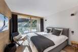 Experience luxury living in this stunning bedroom with breathtaking views.