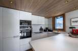 This modern kitchen boasts sleek white cabinetry and a minimalist design, perfect for a contemporary home.