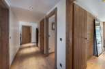 Step into luxury with this stunning hallway featuring exquisite wooden accents and a warm, inviting ambiance.
