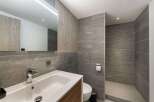 This modern bathroom features a sleek design with a spacious walk-in shower and a stylish vanity.