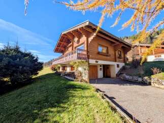 Discover the charm of this stunning wooden chalet nestled in a picturesque setting.