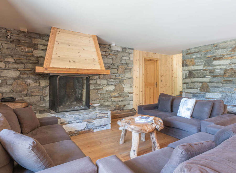 Experience the warmth of this stunning living room, featuring a cozy fireplace and inviting seating.