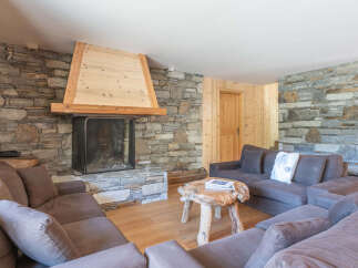 Experience the warmth of this stunning living room, featuring a cozy fireplace and inviting seating.