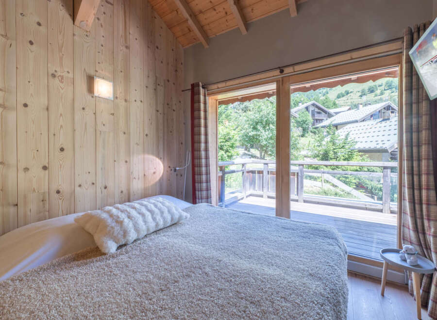 Experience the charm of this cozy bedroom with natural wood accents and a serene ambiance.