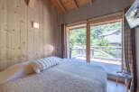 Experience the charm of this cozy bedroom with natural wood accents and a serene ambiance.