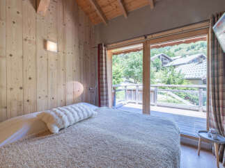 Experience the charm of this cozy bedroom with natural wood accents and a serene ambiance.