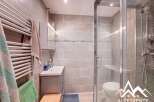 Discover this modern bathroom featuring a sleek shower enclosure and stylish tiled walls.