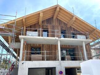 Discover the charm of this stunning new construction home, featuring a beautiful wooden facade and a modern design.