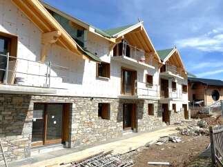 Discover a stunning new construction property featuring a unique stone facade and modern design.