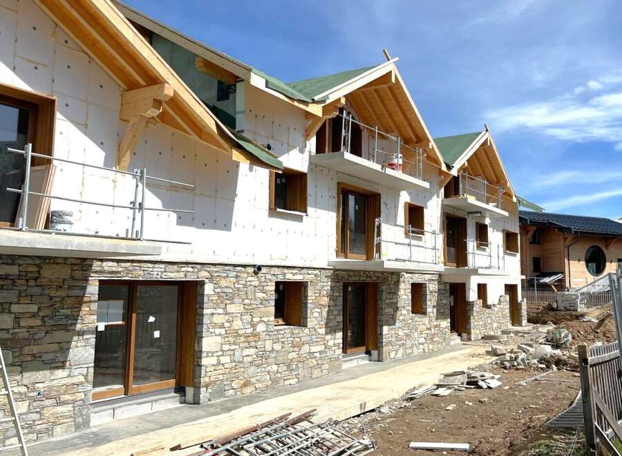 Discover a stunning new construction property featuring a unique stone facade and modern design.